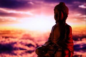 Buddha Purnima and Vesak day concept, Buddha statue with low key light against beautiful and colorful background. Meditation photo