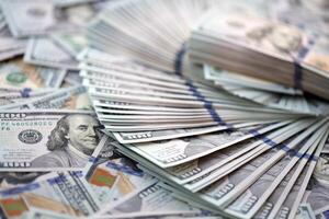 Very big amount of US hundred dollar bills. Huge quantity of united states currency notes on flat table photo