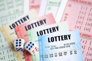 Lottery tickets of different colors and dice on blank bills with numbers for playing lottery photo