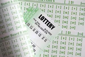 Green lottery tickets and blank bills with numbers for playing lottery photo