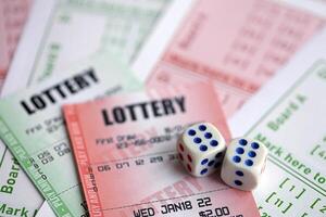 Green and red lottery tickets with dice on blank bills with numbers for playing lottery photo