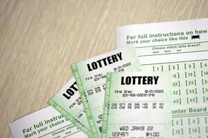 Green lottery tickets and blank bills with numbers for playing lottery photo