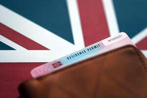 Residence Permit BRP card in purse on Union Jack flag photo