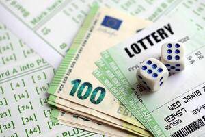 Green lottery tickets and euro money bills on blank with numbers for playing lottery photo