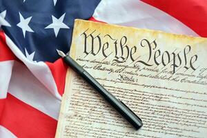 Preamble to the Constitution of the United States and American Flag close up photo