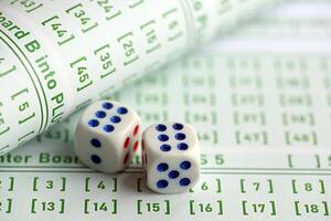 Lottery tickets and dice on blank bills with numbers for playing lottery photo