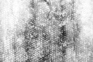 Drop of bee honey drip from hexagonal honeycombs filled with golden nectar photo