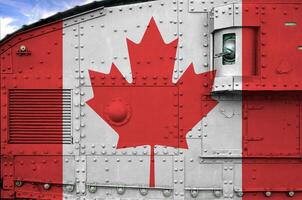 Canada flag depicted on side part of military armored tank closeup. Army forces conceptual background photo