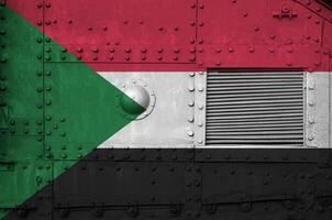 Sudan flag depicted on side part of military armored tank closeup. Army forces conceptual background photo