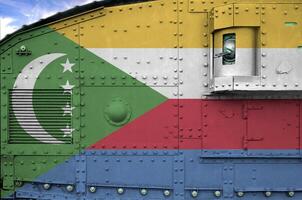 Comoros flag depicted on side part of military armored tank closeup. Army forces conceptual background photo