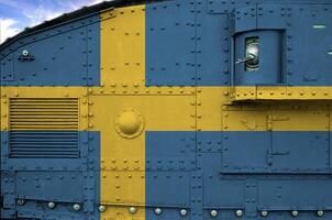 Sweden flag depicted on side part of military armored tank closeup. Army forces conceptual background photo