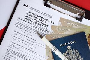 Application for Canadian citizenship for adults on table with pen, passport and dollar bills photo