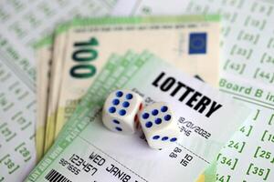 Green lottery tickets and euro money bills on blank with numbers for playing lottery photo