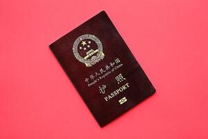 Red passport of People Republic of China. PRC chinese passport on bright background photo