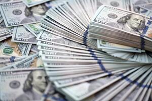 Very big amount of US hundred dollar bills. Huge quantity of united states currency notes on flat table photo