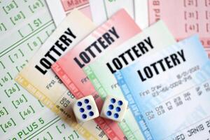 Lottery tickets of different colors and dice on blank bills with numbers for playing lottery photo