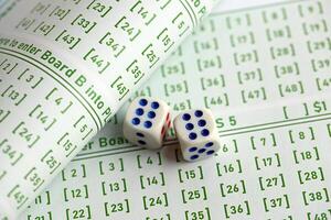 Lottery tickets and dice on blank bills with numbers for playing lottery photo