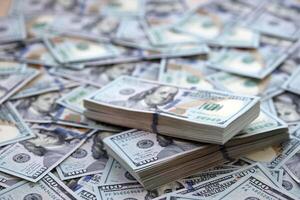 Very big amount of US hundred dollar bills. Huge quantity of united states currency notes on flat table photo