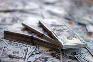 Very big amount of US hundred dollar bills. Huge quantity of united states currency notes on flat table photo
