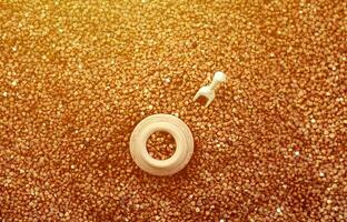 Background image of a large pile of buckwheat, in the middle of which lies a small jug and a wooden spatula for cereals photo