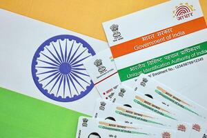 Indian Aadhaar card from Unique Identification Authority of India on Indian flag photo