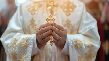 Hands of a priest with a cross in the midst of a sacred blessing ritual, embodying devotion and reverence photo