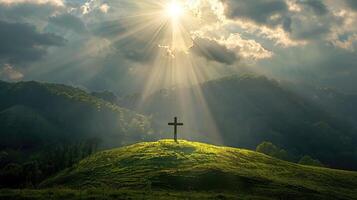 Radiant beam of sunlight breaking through clouds, illuminating a cross on a hill with lush green fields below photo