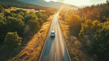 Car driving on a long open road surrounded by scenic nature during a family road trip, adventure concept. Summer vacation, tourism photo