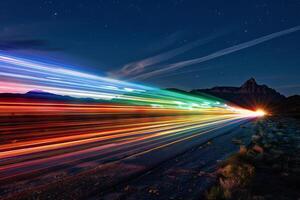 Rainbow-colored light trails transparently streaking across the night sky photo