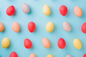 Colorful Easter eggs arranged in a playful pattern against a pastel backdrop photo