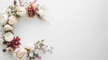 A white background with a flower arrangement in the center. The flowers are pink and white. The arrangement is circular and has a wavy design photo
