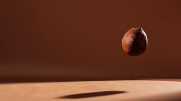 Bold silhouette of levitating hazelnut in a minimalist brown composition photo