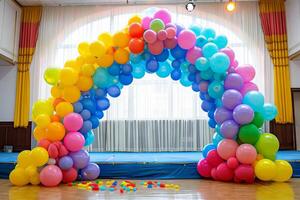 Colorful balloon arch framing a stage at a school event, creating a fun and festive atmosphere photo