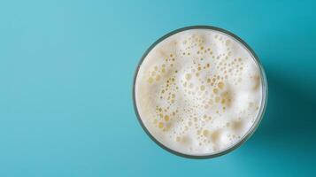 Top-down shot of a spinning glass of milkshake with room for text photo
