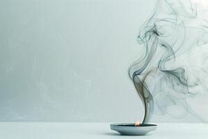 Burning incense releasing fragrant smoke against a transparent white backdrop, ideal for spiritual and mystical themes photo