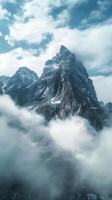 Rocky mountain peaks piercing the clouds photo
