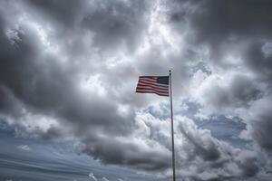 American flag on a pole against a cloudy sky photo