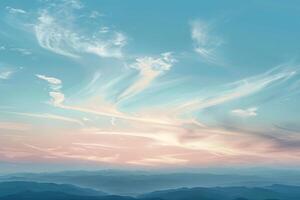 A tranquil sky background, with wispy clouds casting shadows on the landscape below photo