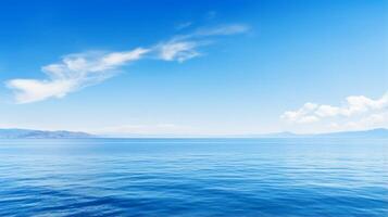 Serene lake reflecting a clear blue sky photo