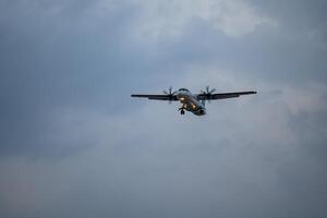 Airplane registration flying on cloudy day, approaching landing in Tan Son Nhat Airport in Vietnam photo