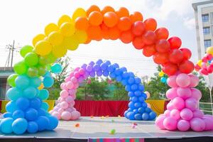 Colorful balloon arch framing a stage at a charity event, creating a festive backdrop photo
