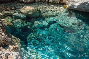 Crystal-clear water of a natural spring bubbling up from the ground photo