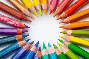 Rainbow-colored crayons arranged transparently in a circular pattern photo