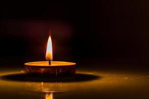 Flickering candle flame illuminating the darkness against a transparent white surface, perfect for meditation and relaxation photo