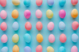 Colorful Easter eggs arranged in a pattern against a pastel backdrop photo