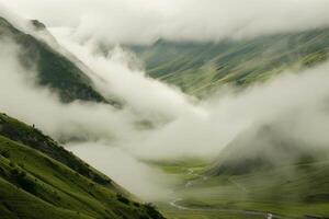Rolling fog in a mountain valley photo