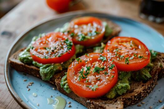 Plate of whole grain toast with avocado spread and sliced tomatoes, a healthy breakfast photo