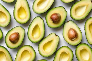 Sliced ripe avocado arranged neatly on a transparent white surface photo