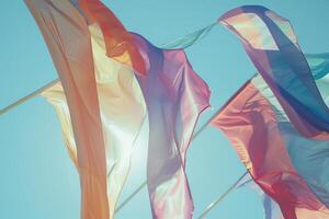 Rainbow-colored flags transparently waving in the wind photo