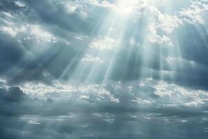 The sky is cloudy and the sun is shining through the clouds. The sun is casting a warm glow on the clouds, creating a peaceful and serene atmosphere photo